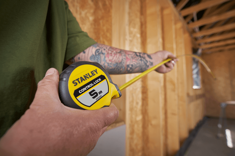 STANLEY® CONTROL-LOCK™ 5M (25mm wide) Tape Measure being used by worker on site in extended reach position